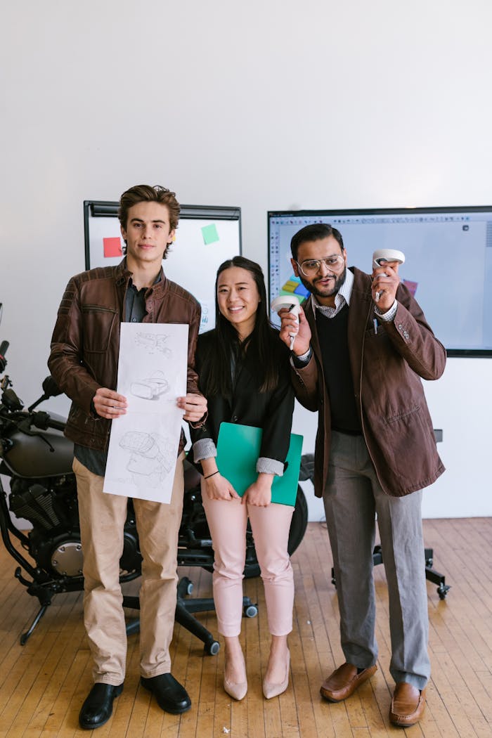 who-we-are Three diverse entrepreneurs showcasing their startup ideas with creativity and collaboration indoors.
